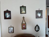 Overview of six framed portrait miniatures mounted on wall