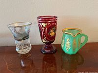 All three art glass pieces side by side on tabletop