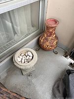 Both the concrete planter and ceramic urn on balcony