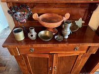 Full lot on wooden sideboard displaying all nine decorative pieces