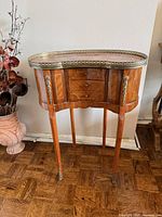 Full view of kidney-shaped side table front and side