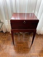 Front view of closed wood box on stand