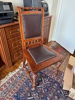 Full view of chair front, showing leather backrest and seat