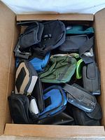 Overview of box with multiple phone cases in various colors and styles