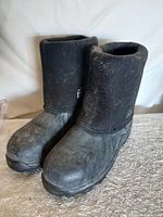 Front angled view of both boots showing rubber lower and neoprene shaft