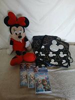 Full lot showing Minnie plush, Mickey backpack, three Frozen invitation packs