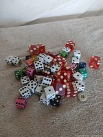 Pile of mixed casino and standard dice on cloth surface