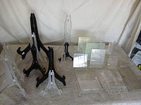 Overview of assorted acrylic and wood display stands on table