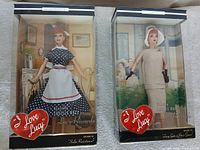 Front view of both boxed dolls