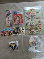 Assorted One Piece collectible items laid out
