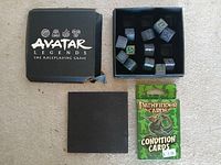 Avatar Legends dice box opened with 12 dice and Pathfinder card deck