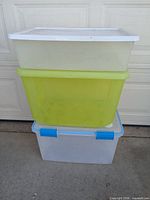 Stack of three plastic totes in garage setting