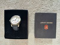 Watch in open box next to branded outer box