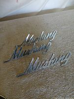 Overall view showing three chrome Mustang script emblems