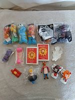Array of all items laid out showing plush, sealed bags, figures, novelties