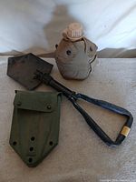 Entenching tool folded, carrier, canteen with cover