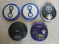 Front view of five portable CD players arranged on surface