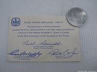 Front of card with medallion showing crest and text