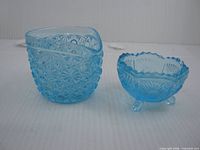 Top and side view of both blue glass pieces highlighting Daisy & Button pattern