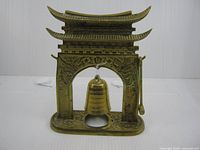 Front view showing full brass pagoda frame, bell, and striker