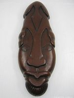Front view showing full carved face mask