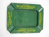 Full view of green enamel Dawes advertising ashtray