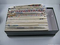 Box filled with envelopes showing thickness and storage box