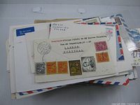 stack of assorted stamped envelopes, front view