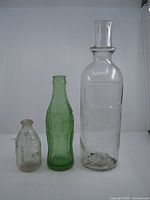 Group shot of all three glass bottles showing relative sizes and colours