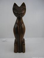 Front view of carved wood cat figurine