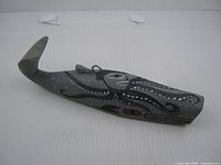 Profile view of entire carved whale with painted octopus