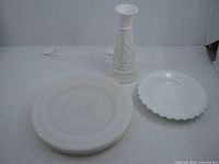 Overall view: three dinner plates stacked, scalloped dessert plate, bud vase