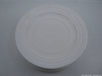 stack of white milk glass side plates, top view showing rim rings