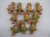 All ten Kewpie dolls arranged on white background