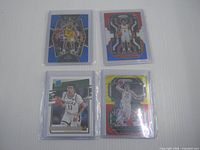 Front view of all four sleeved cards