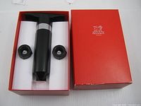 Vacuum pump with two stoppers in open red box