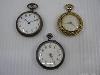 Front view of all three pocket watches showing dials and cases