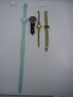 All four wristwatches laid out for size comparison