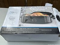 Retail box showing Mainstays 14-Quart Roaster Oven with product details