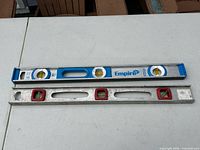 Both 24-inch metal levels side by side on table