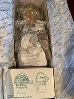 Doll in box wrapped in bubble wrap with accessories box visible