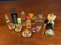 Group shot of all 14 perfume bottles and one box