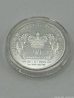 Reverse of coin showing crown, wattle sprays, 90th Birthday inscription and silver purity