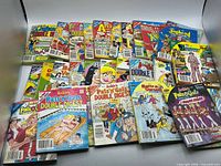 Full spread showing approximately 22 Archie digest comics laid out