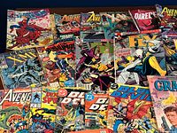 Overview showing assorted Marvel, DC and other comics spread on table
