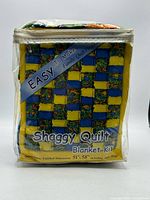 Front of sealed shaggy quilt blanket kit package showing product name and size