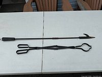 Poker and grabber laid out on table