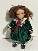 Front view of Hannah doll in green velvet dress
