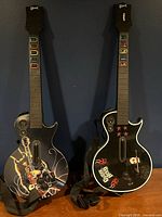 Front view of both Guitar Hero PS3 guitars with straps