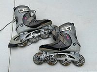 Pair of K2 Athena inline skates side view showing five-wheel frames and pink ribbon logo